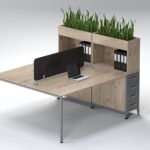 Face-to-face oak workstation with slate grey drawers and black acoustic screen.