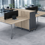 A modern 4-person office workstation featuring light oak wood desktops, slim metal legs, black privacy screens, and integrated slate grey vertical storage cabinets.